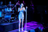 Mariah Carey performs on stage in small silver dress showing her legs and cleavage at Time Magazine 100 Most Influential People Event